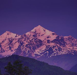 Sunset evening view over the snowy mountain peak stock photo containing