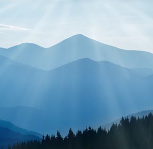 Sunset in the mountains containing blue, mountains, and sunset