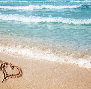 Hearts drawn on the beach sand stock photo containing heart and shape
